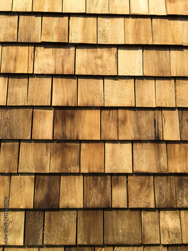 A background of newly installed cedar shingles.