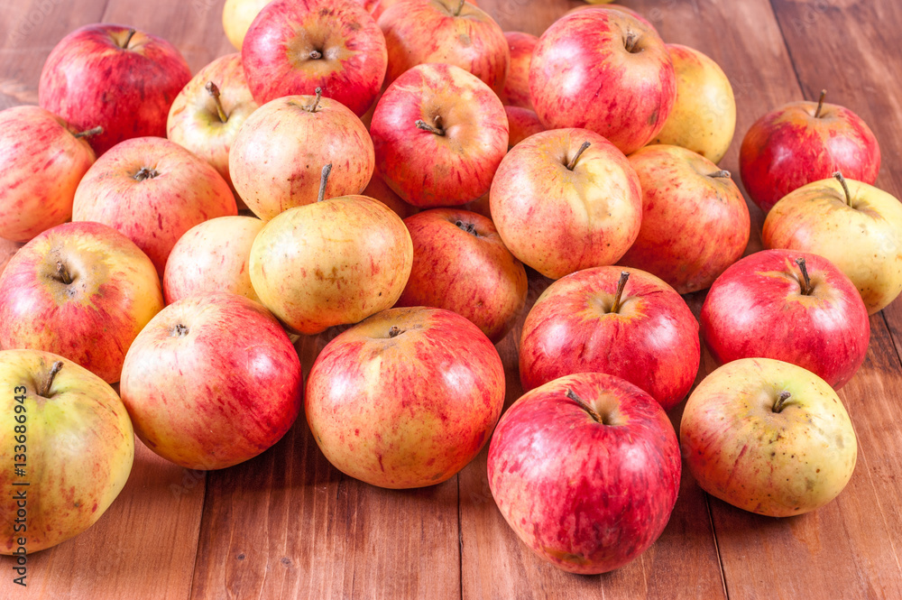 Harvested apples lie on a wooden background. Harvested apples lie on a wooden background.