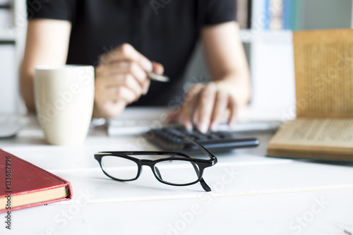 Businesswoman working with calculator in the office workplace