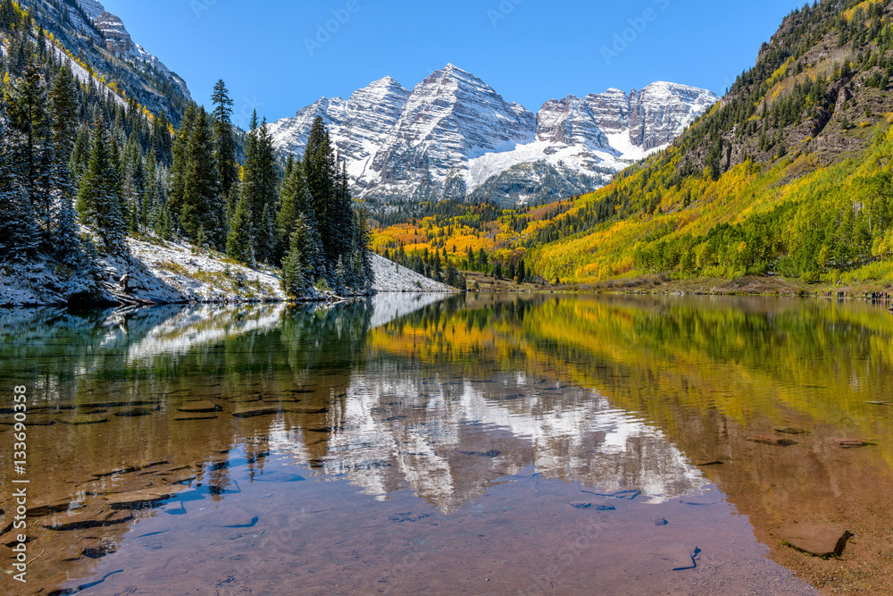 Maroon Bells in Autumn - Autumn view of snow coated Maroon Bells reflecting in crystal clear Maroon Lake, Aspen, Colorado, USA.