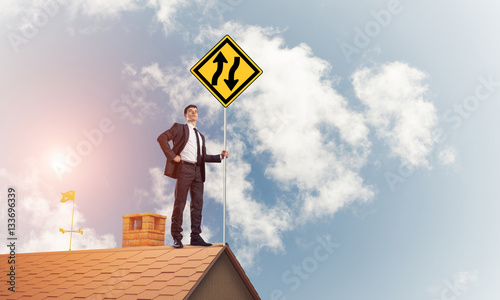 Mister boss on brick roof with sign in hands. Mixed media photo