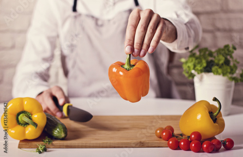 Chef's hands. Man is ready to prepare fresh salad. photo