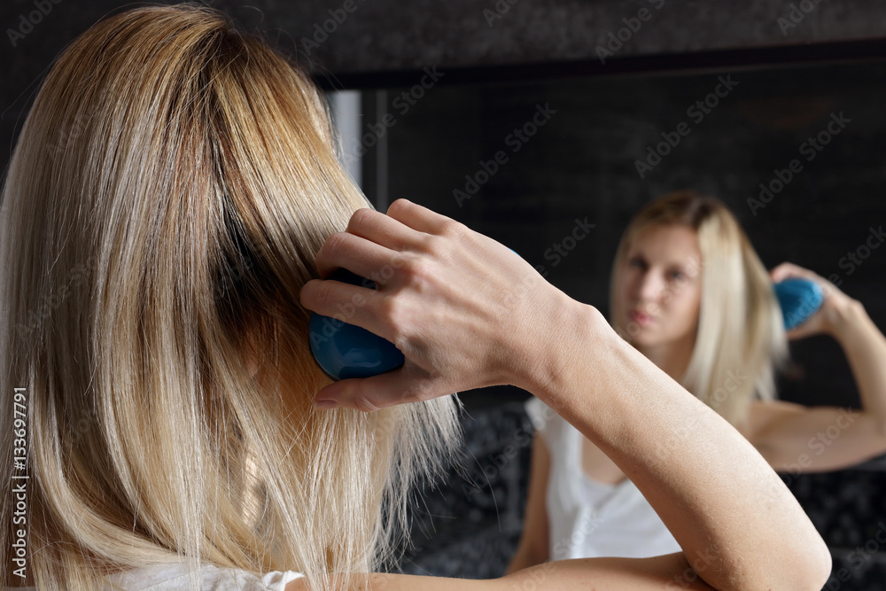 Obraz premium Portrait of Happy Smiling Woman brushing Healthy Long Straight Hair. Haircare and beauty concept