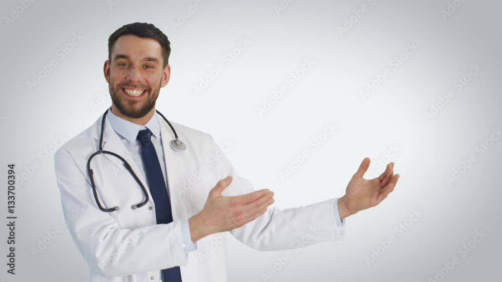 Mid Shot of a Doctor Making Presenting Gesture and Smiling. Shot on White Background. Shot on RED Cinema Camera 4K (UHD). Mid Shot of a Doctor Making Presenting Gesture and Smiling. Shot on White Background. Shot on RED Cinema Camera 4K (UHD).