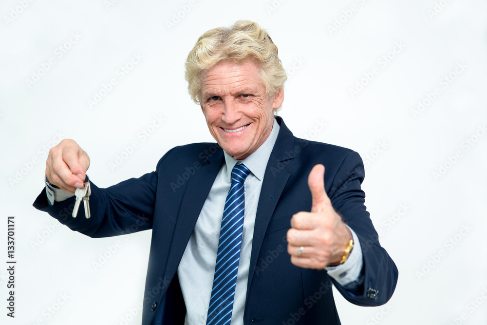 Happy Senior Businessman Showing Keys and Thumb Up Happy Senior Businessman Showing Keys and Thumb Up