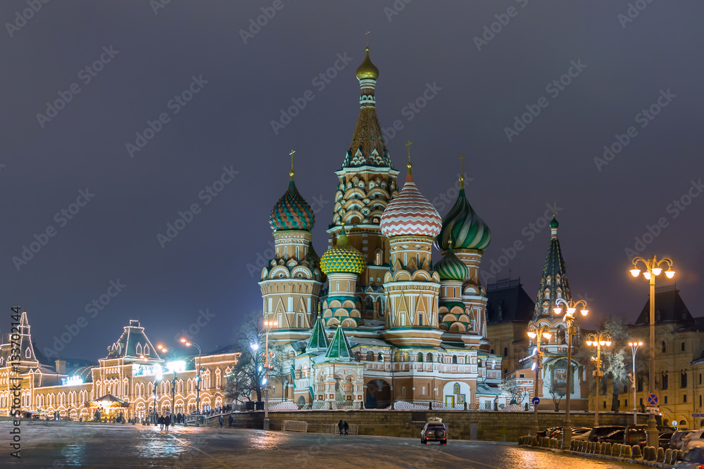 Russia, Moscow. View on a Red Square from the Moskvaretsky bridge, St. Basil Cathedral on the right, State Department Store is on the right. Evening, snow, winter. Russia, Moscow. View on a Red Square from the Moskvaretsky bridge, St. Basil Cathedral on the right, State Department Store is on the right. Evening, snow, winter.