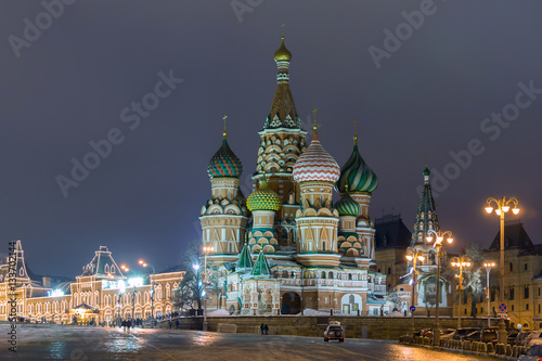 Russia, Moscow. View on a Red Square from the Moskvaretsky bridge, St. Basil Cathedral on the right, State Department Store is on the right. Evening, snow, winter.