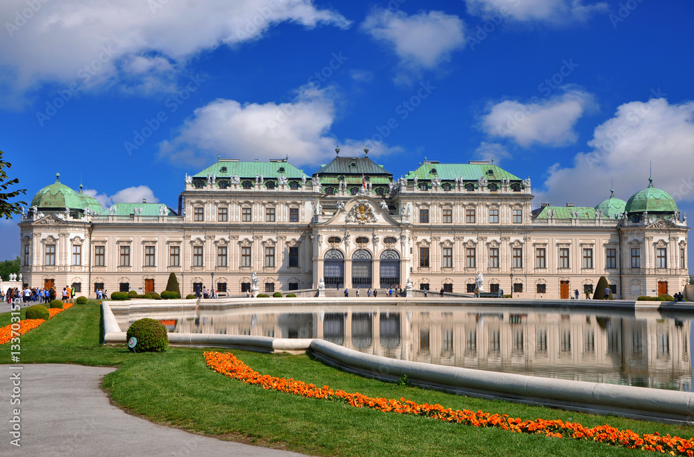 View of famous Belvedere palace with a reflection in pool and blue sky, in Vienna, Austria 