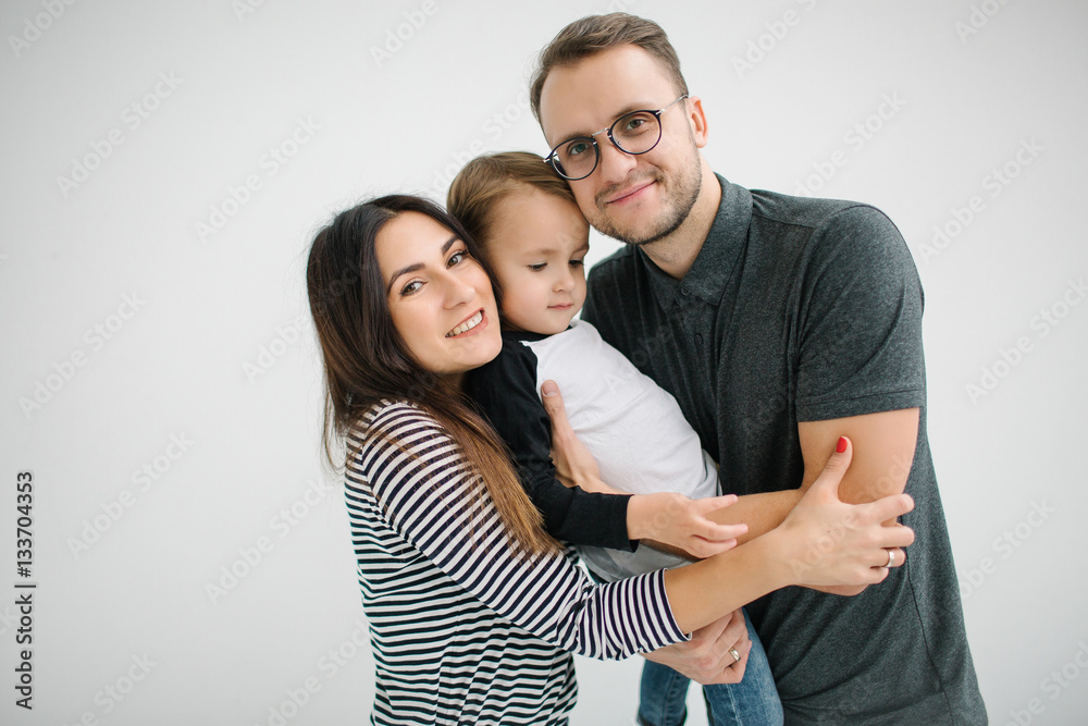 Hipster father, mother holding baby boy over white isolated back Hipster father, mother holding baby boy over white isolated back