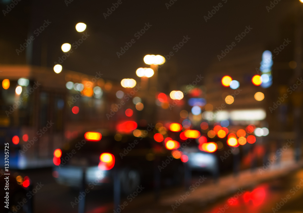 Night road in the city, cars light in traffic jams, defocused,