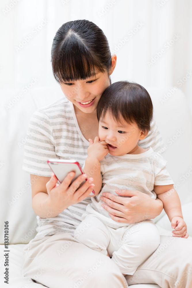asian mother and baby using smart phone asian mother and baby using smart phone