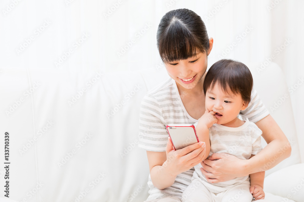 asian mother and baby using smart phone asian mother and baby using smart phone