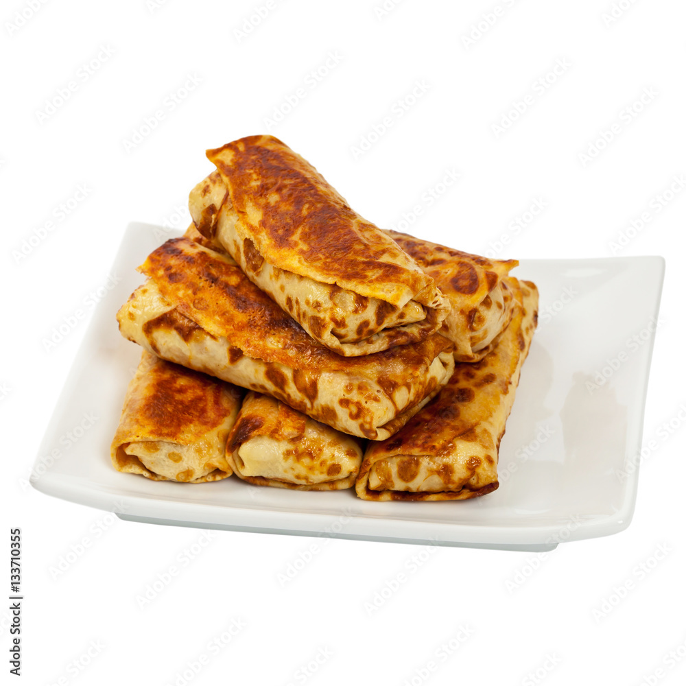 Russian Stuffed Pancakes Blintzes with Meat Isolated on White. Selective focus. Russian Stuffed Pancakes Blintzes with Meat Isolated on White. Selective focus.