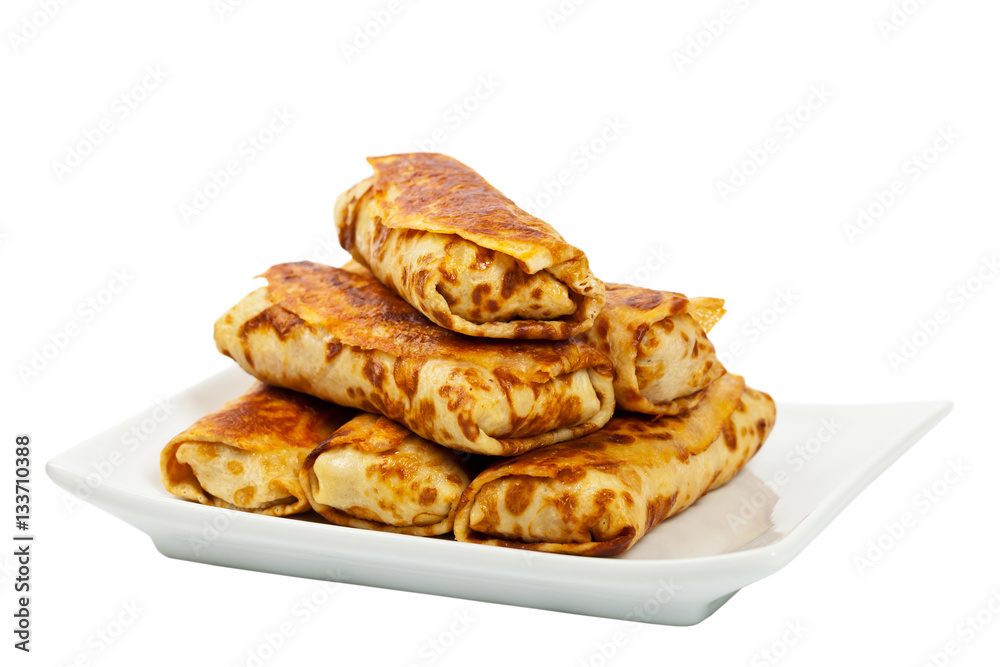 Russian Stuffed Pancakes Blintzes with Meat Isolated on White. Selective focus. Russian Stuffed Pancakes Blintzes with Meat Isolated on White. Selective focus.