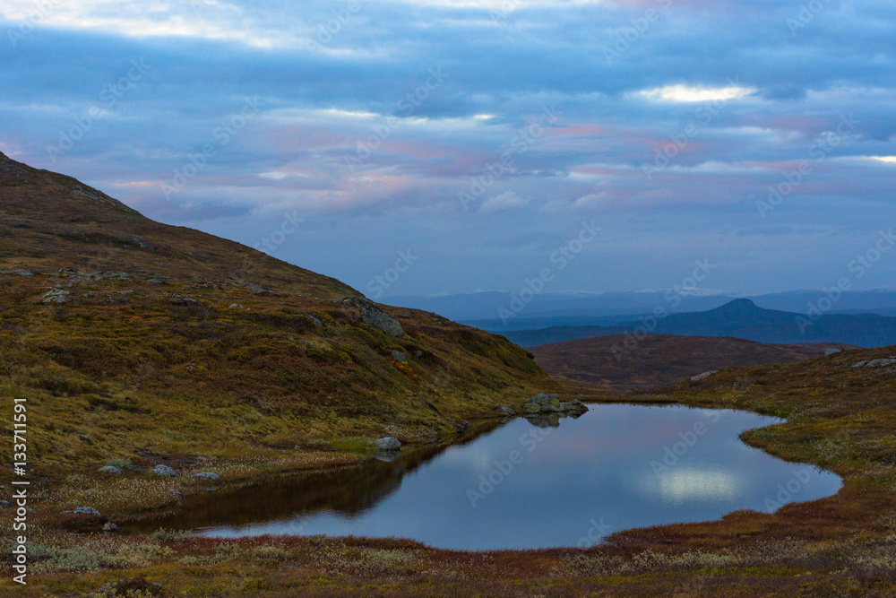 Fototapeta premium Water pool reflecting sky high up in the mountains