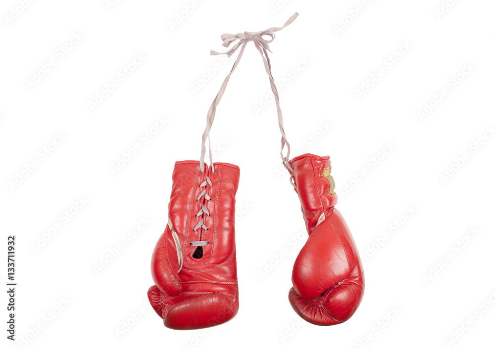 old used and battered red leather boxing gloves, isolated on white background