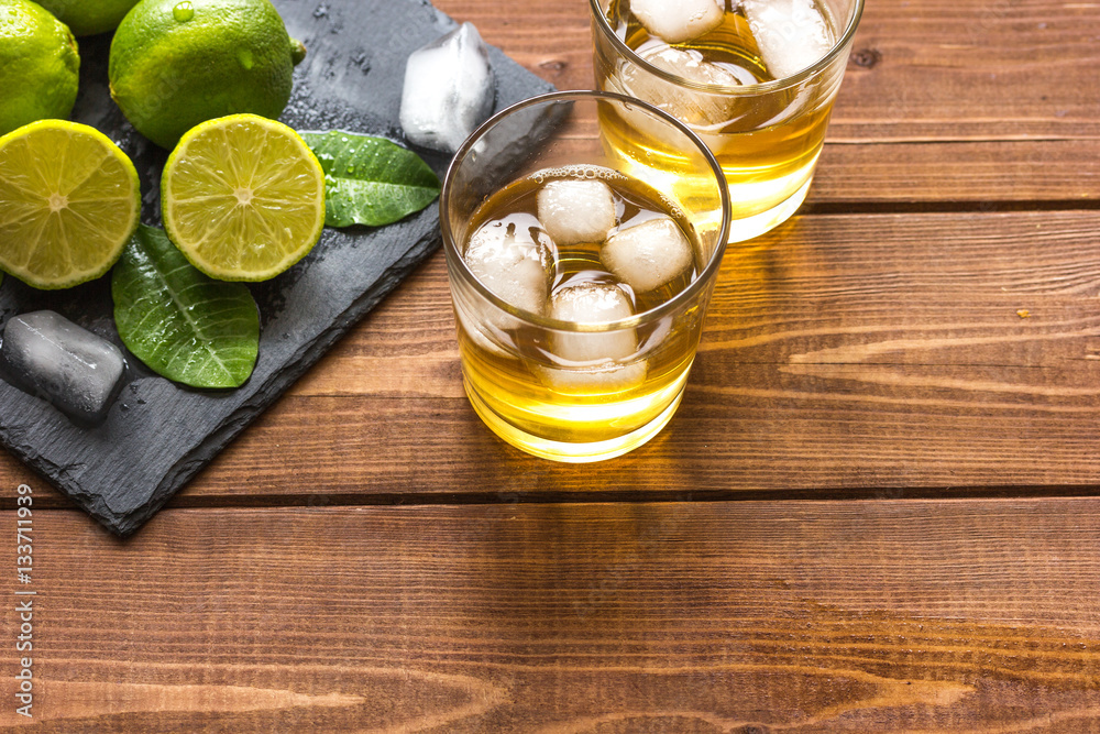 glass of whiskey on wooden background glass of whiskey on wooden background