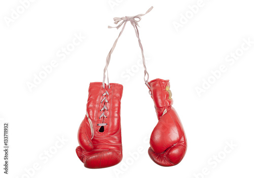 old used and battered red leather boxing gloves, isolated on white background © monicaclick