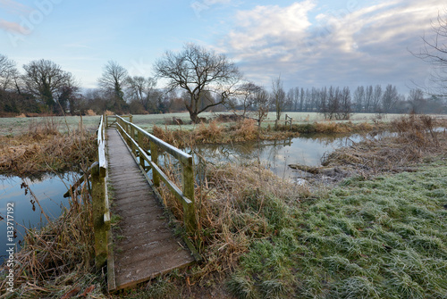Wooden footbridge over a small river on a frosty morning © Peter Cripps