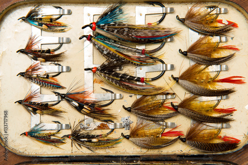 Close up of salmon flies in tin