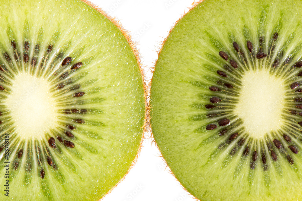 Two halves of a ripe kiwi fruit shot side by side and close upon a 100% white background Two halves of a ripe kiwi fruit shot side by side and close upon a 100% white background