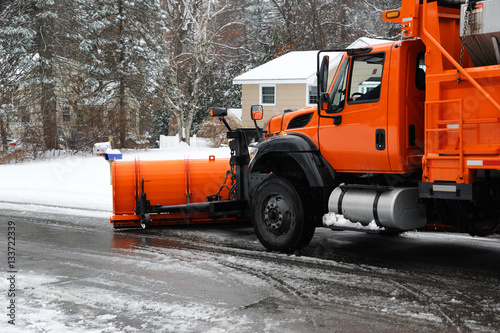 snowplow removing snow in the street after blizzard