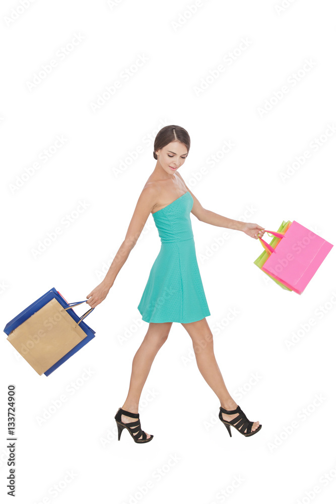 happy shopping woman swinging shopping bag while walking