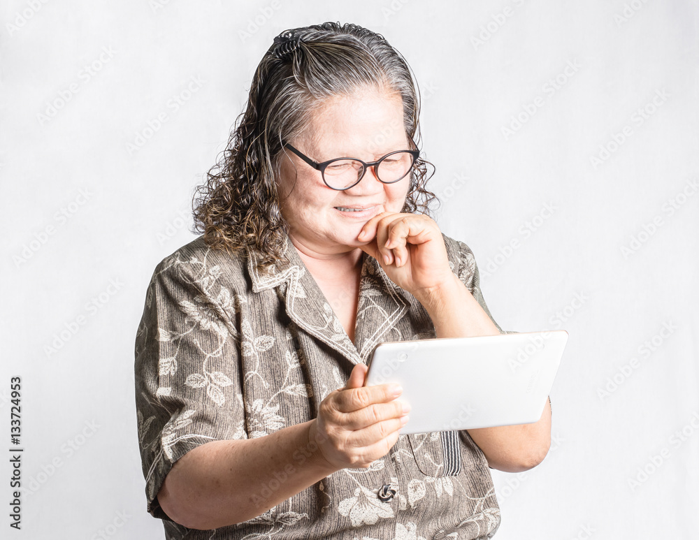 portrait of a mature woman using smart phone. Isolated on grey b portrait of a mature woman using smart phone. Isolated on grey b