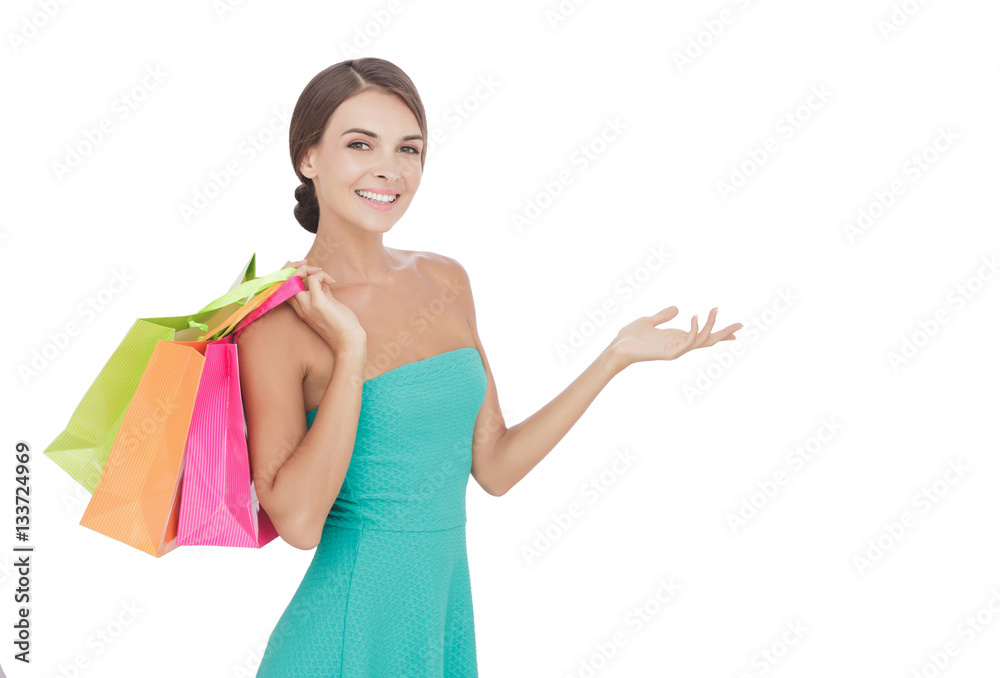 beauty woman carrying shopping bags while presenting beauty woman carrying shopping bags while presenting