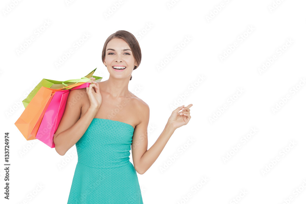 beauty woman carrying shopping bags while pointing at copy space beauty woman carrying shopping bags while pointing at copy space