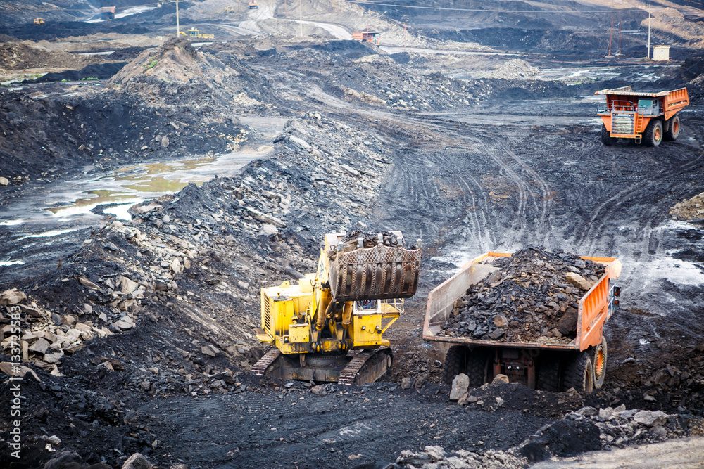 Mining dump trucks working in Lignite coalmine
