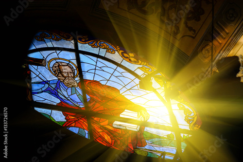 The Bernardine church and monastery (church of St. Andrew) in Lviv, Ukraine. Church and fortification was built in 1600-1630. Beautiful stained glass window with sunlight. Religion and art concept.