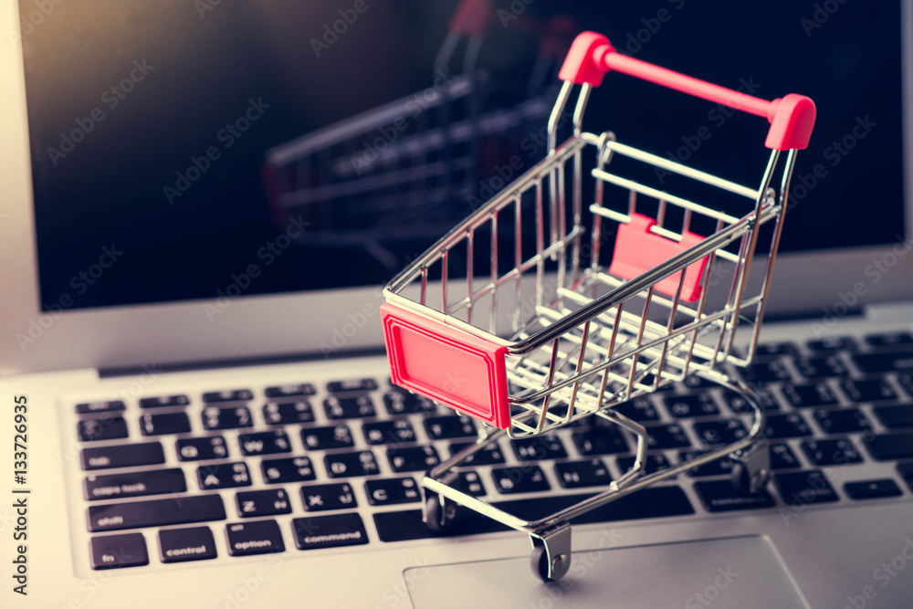 Tablet and shopping cart on wood table, Online shopping concept