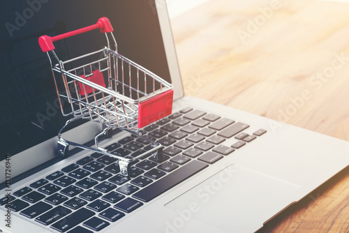 Tablet and shopping cart on wood table, Online shopping concept