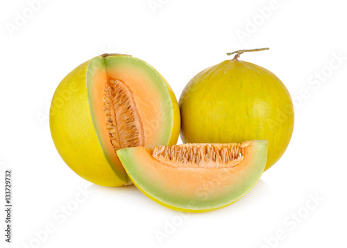 whole and cut fresh yellow melon with stem on white background