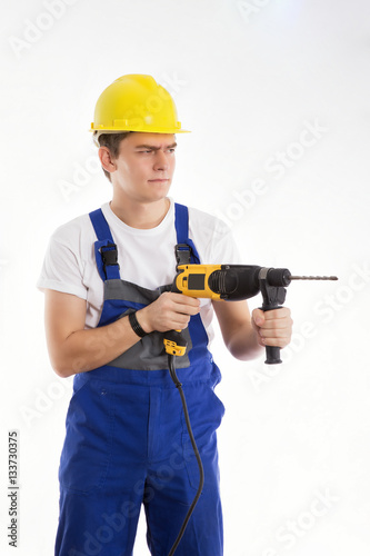 Construction worker with a drill on a white background