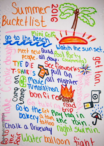 A teenagers bucket list for the summer written in bright colorful markers on a white background photo