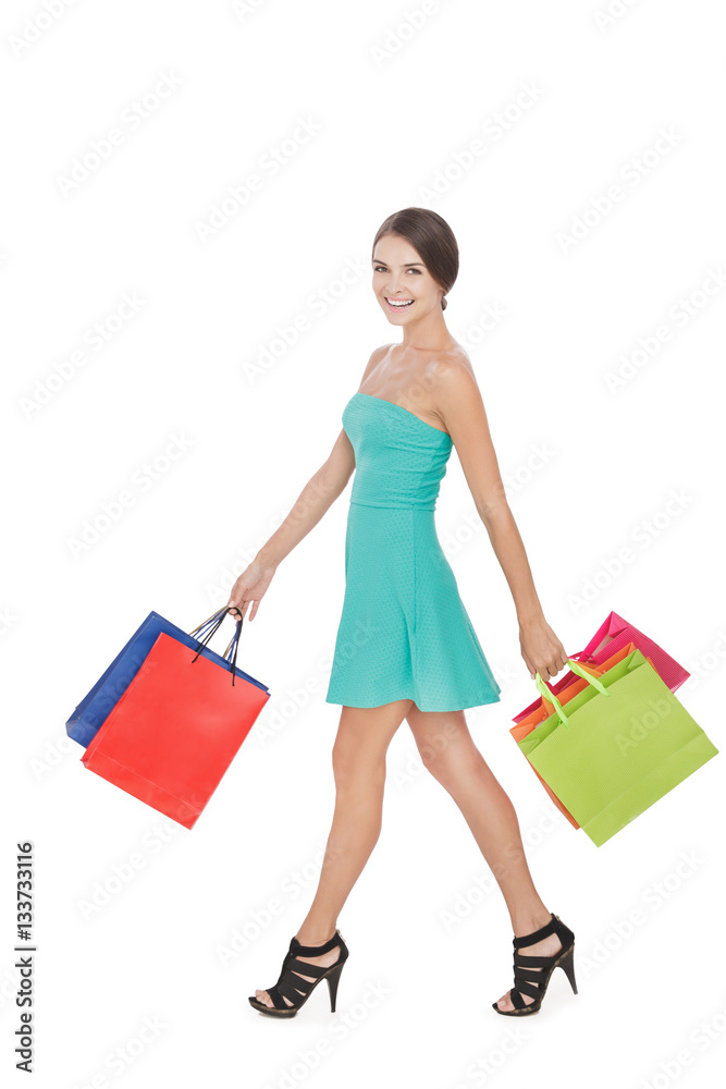 happy shopping woman carrying shopping bag while walking