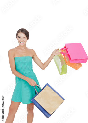 happy young shopping girl swinging shopping bag