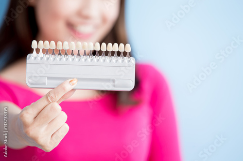 woman hold teeth whitening tool