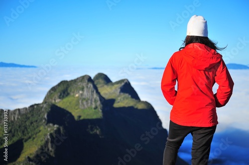 Young Woman on Mountain Peak  © karinkamon