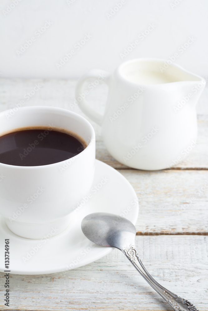 Black coffee in a white cup on a white background Black coffee in a white cup on a white background
