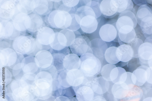 Abstract background blurred white bokeh circles.