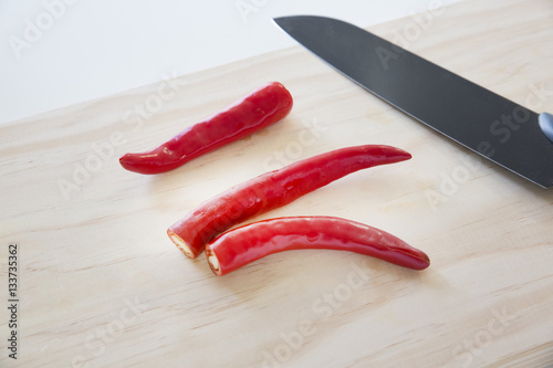 Red chilli peppers on cutting board