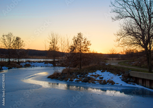 sunset on frozen pond along nature trail in woods © David Prahl