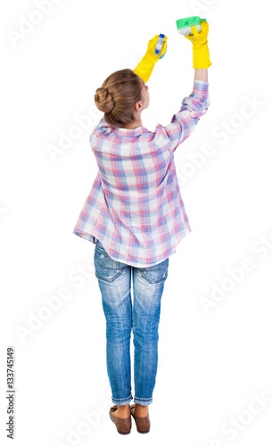 Back view of a housewife in gloves with sponge and detergent. girl watching. Rear view people collection. backside view of person. Isolated over white background. Girl in a checkered red shirt