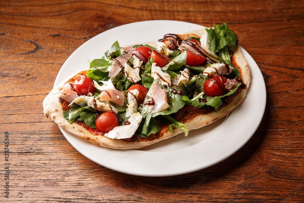 arugula pizza on table arugula pizza on table