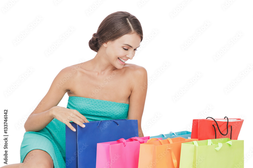 beautiful young woman sitting on the floor next to her shopping beautiful young woman sitting on the floor next to her shopping