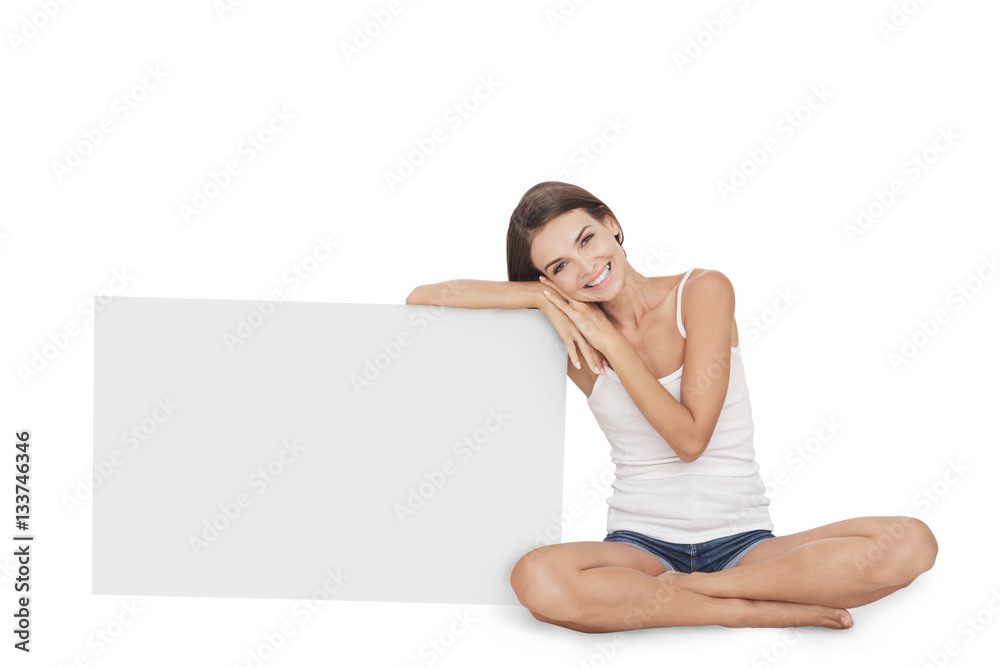 beautiful young woman smiling while leaning on blank board beautiful young woman smiling while leaning on blank board