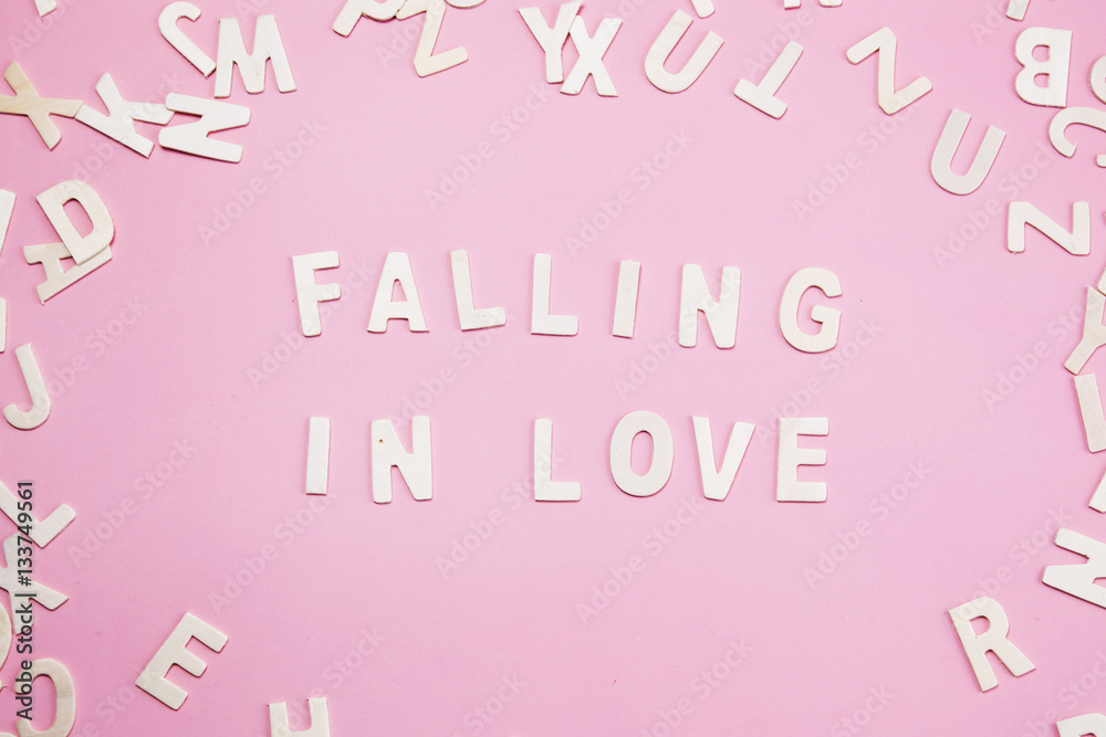 Sorting letters Fall in love on pink.